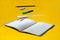 Levitating school supplies for math - notebook, pen, ruler, pencil, divider and eraser on yellow background. Concept of education