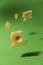 Levitation background. Chunks of cheese with holes floating in the air.