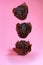 levitation of chocolate chip muffins isolated on pink background
