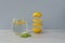 Levitation of cutted lemon, glass of water with lemon and leaf of mint is near on light background, copyspace.