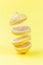 Levitation of lemon slices on  yellow background, vertical, closeup