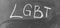 LGBT, abbreviation for LGBT. A symbol of free love. Hand written letters in white chalk on a school blackboard. Black