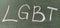 LGBT abbreviation written in white chalk on a green school board. Diversity of sexuality and gender identity based on culture.