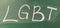 LGBT abbreviation written in white chalk on a green school board. Diversity of sexuality and gender identity based on culture.