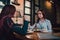 LGBT Cheerful female friends chatting in cafe. Two beautiful young women gossiping and drinking coffee. Friendship