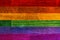 LGBT civil rights rainbow flag painted on wood planks. Copy space for text or graphic.