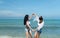 LGBT couples traveling around Asia, Swim happily on the sandy beach with the beautiful blue sea