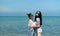 LGBT couples traveling around Asia, Swim happily on the sandy beach with the beautiful blue sea