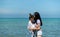 LGBT couples traveling around Asia, Swim happily on the sandy beach with the beautiful blue sea