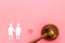 LGBT divorce. Judge gavel, rings, female couple on pink background top-down copy space