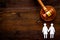 LGBT divorce. Judge gavel, rings, female couple on wooden background top-down copy space