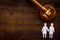 LGBT divorce. Judge gavel, rings, female couple on wooden background top-down copy space