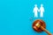 LGBT divorce. Judge gavel, rings, men gay couple on blue background top-down copy space