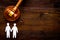 LGBT divorce. Judge gavel, rings, men gay couple on wooden background top-down copy space