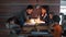 LGBT family with children in a restaurant sitting at a table.