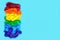 LGBT flag painted isolated on a blue background. Multicolored LGBT symbol color balloons. Copy space