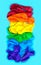 LGBT flag painted isolated on a blue background. Multicolored LGBT symbol color balloons. Copy space