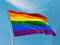 Lgbt flag on a pole waving. Lgbt realistic flag waving against clean blue sky.