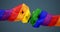 LGBT flag textured human fists. 3D illustration