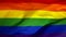 LGBT flag waving in the wind close-up.