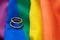 LGBT Gay marriage. Pair of golden rings on rainbow color textile, close up view. Copy space