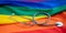 LGBT Health care. Medical Stethoscope on rainbow pride flag background, overhead view