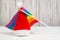 LGBT and New Years concept. Rainbow flag and santa hat on a white wooden background