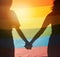 LGBT, rainbow flag and couple silhouette holding hands for gay pride, non binary support or lesbian love. LGBTQ