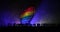 Lgbt rights concept, Silhouette of crowd standing against a heart painted like a LGBT flag in dark background. Selective focus