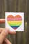 LGBT symbol. Hand holding watercolor rainbow heart.