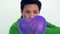 LGBT tomboy lesbian woman abstract wonder about love holding purple heart balloon