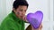 LGBT tomboy lesbian woman abstract worry about love holding purple heart balloon