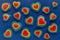 Lgbt Valentines day background - rainbow hearts as abstract pattern on dark blue backdrop, top view.