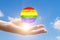 Lgbt world concept, global solidarity with sexual minorities,hand with planet in lgbtq flag colors,Element of the image provided