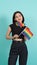 LGBTQ girl and pride flag. Sexy Lesbian girl and LGBT flag standing. blue green background. Asian LGBTQ woman with rainbow scarf o