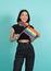 LGBTQ girl and pride flag. Sexy Lesbian girl and LGBT flag standing. blue green background. Asian LGBTQ woman with rainbow scarf o