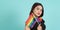 LGBTQ girl and pride flag. Sexy Lesbian girl and LGBT flag standing. blue green background. Asian LGBTQ woman with rainbow scarf o