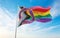 LGBTQ Inclusive Progressive Pride flag waving in the wind at cloudy sky. Freedom and love concept. Pride month. activism,