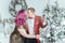 LGBTQ lesbian couple celebrating Christmas or New Year winter holiday together. Gay female lady with butch partner decorating