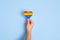 LGBTQ rights concept, Rainbow heart shaped hand on blue background