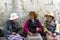 Lhasa, Tibet, China, Chengguan District, June 22 2019: Monastery Sera three women in traditional clothes chat on a bench