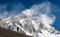 Lhotse with windstorm, turist and snow clouds