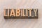 Liability word abstract in wood type