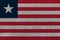 Liberia flag on the background texture. Concept for designer solutions
