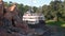 Liberty Square Riverboat sailing and people enjoying Big Thunder Mountain Raildroad at Magic Kingdom