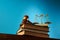 libra scale and gavel hammer on stack of books against blue background