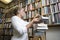 Librarian Arranging Books At Library