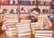 Librarian concept. Man on happy face between piles of books, while studying in library, bookshelves on background
