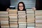 Librarian women in glasses at wall of books archives.