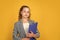 Library assistant. Happy girl hold library folder. School library. Knowledge and information. Student teen formal style